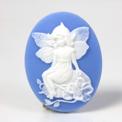 Plastic Cameo - Fairy Sitting on Garden Stone Oval 40x30MM WHITE ON BLUE